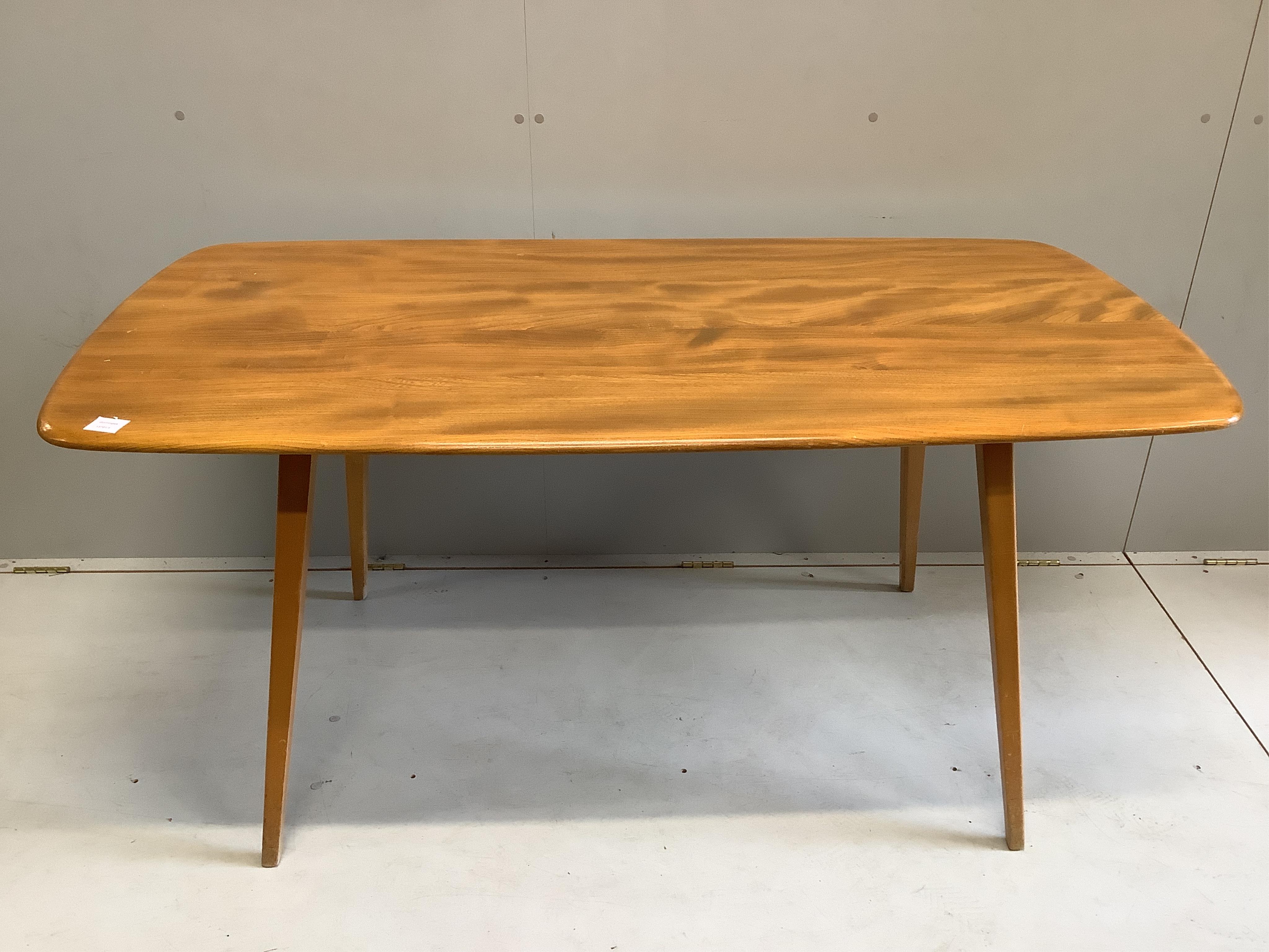An Ercol rectangular elm dining table, width 150cm, depth 75cm, height 71cm together with six Ercol comb back dining chairs